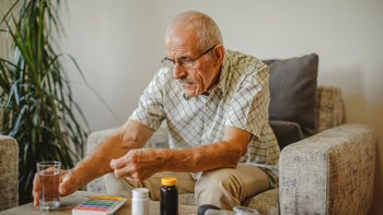 Health: Benign Prostatic Hyperplasia: senior man taking medicine at home GettyImages-1339134000