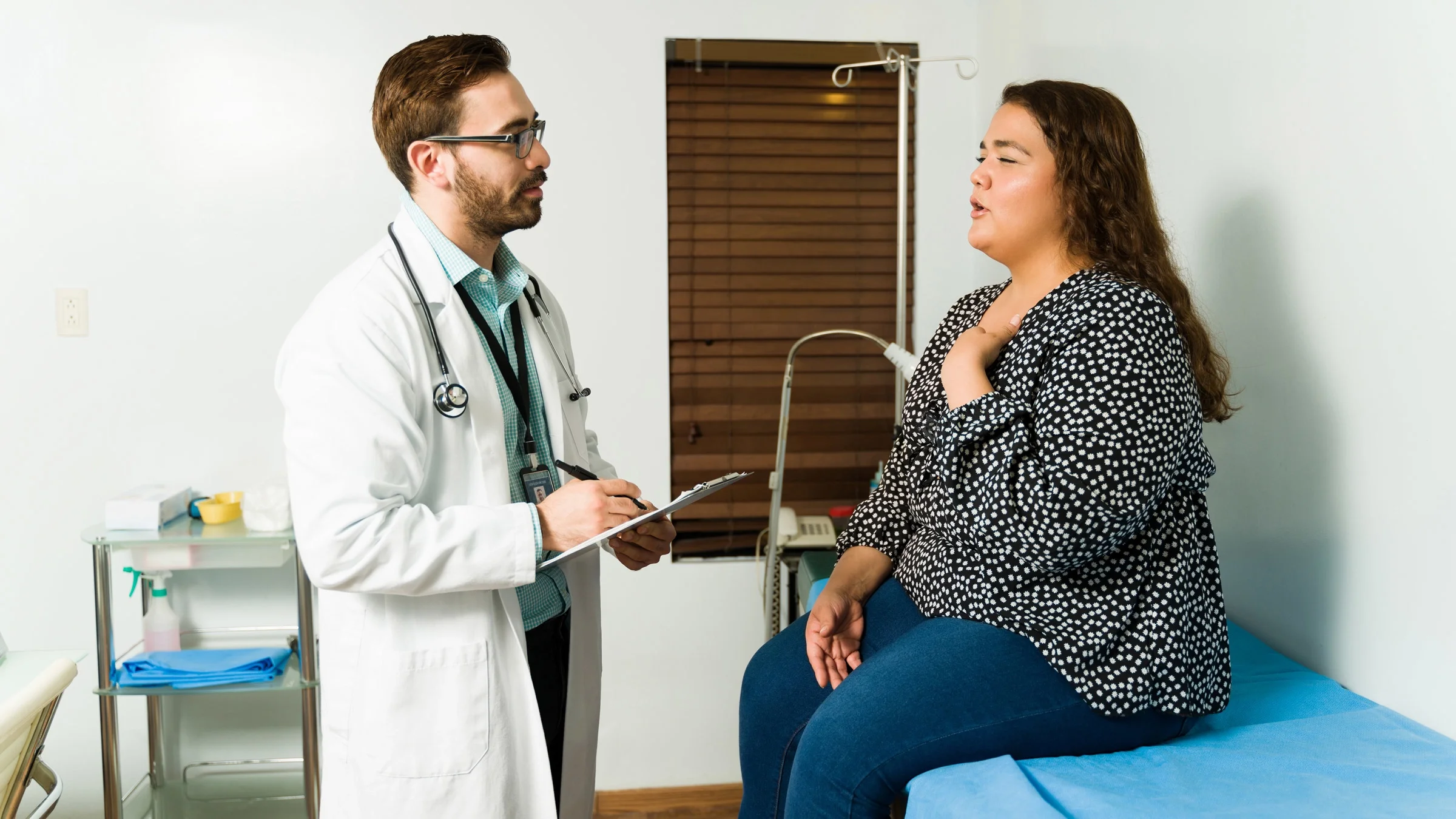 A patient with chest pain talking to their doctor.
