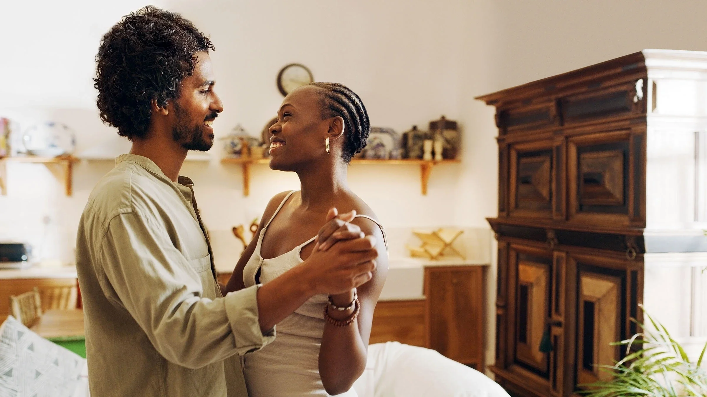 Couple dancing together in their living room at home