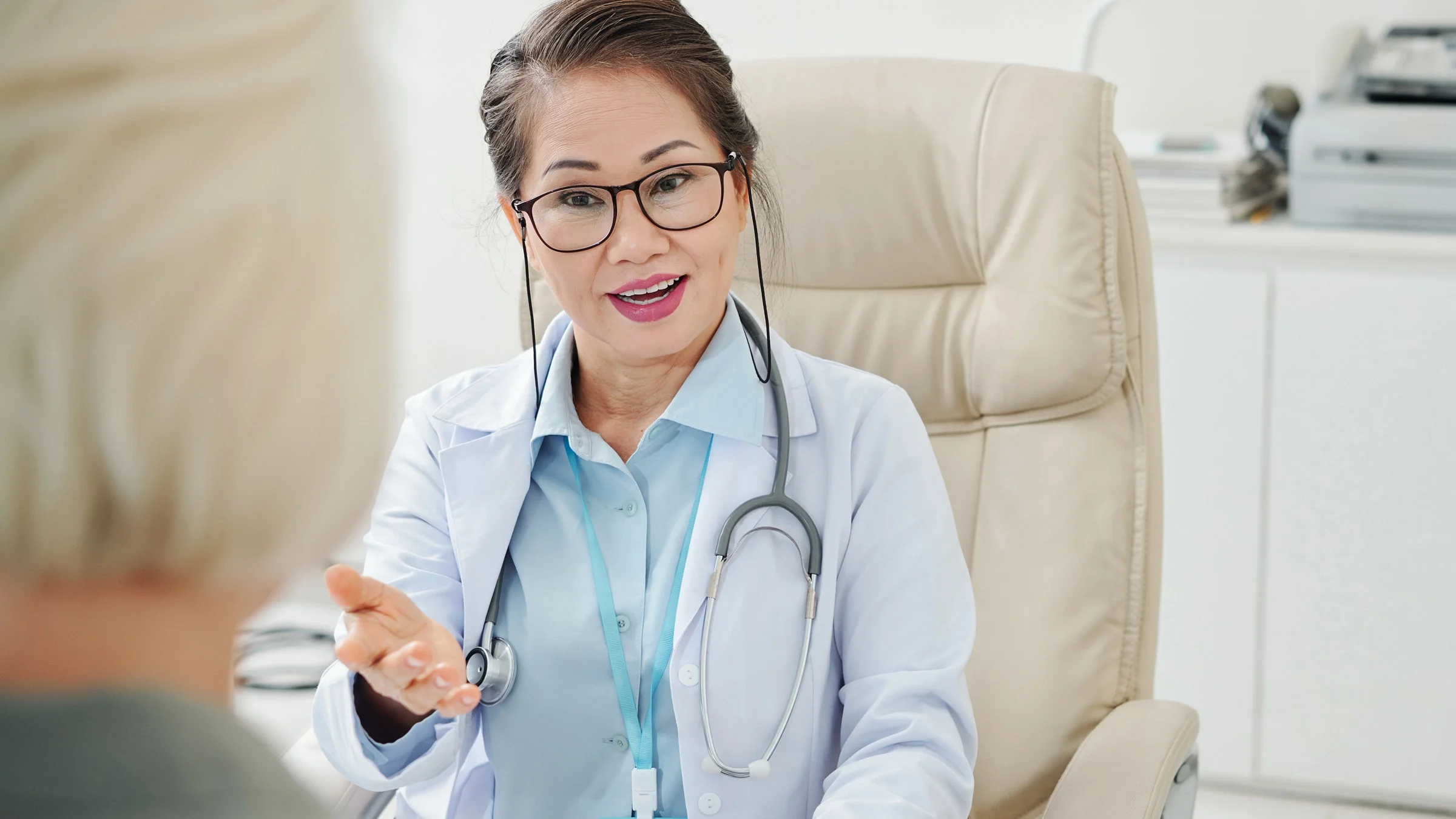 A doctor conversing with a patient.