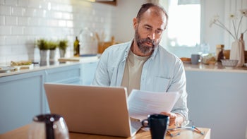Health-insurance: man doing paperwork at home 1450017520
