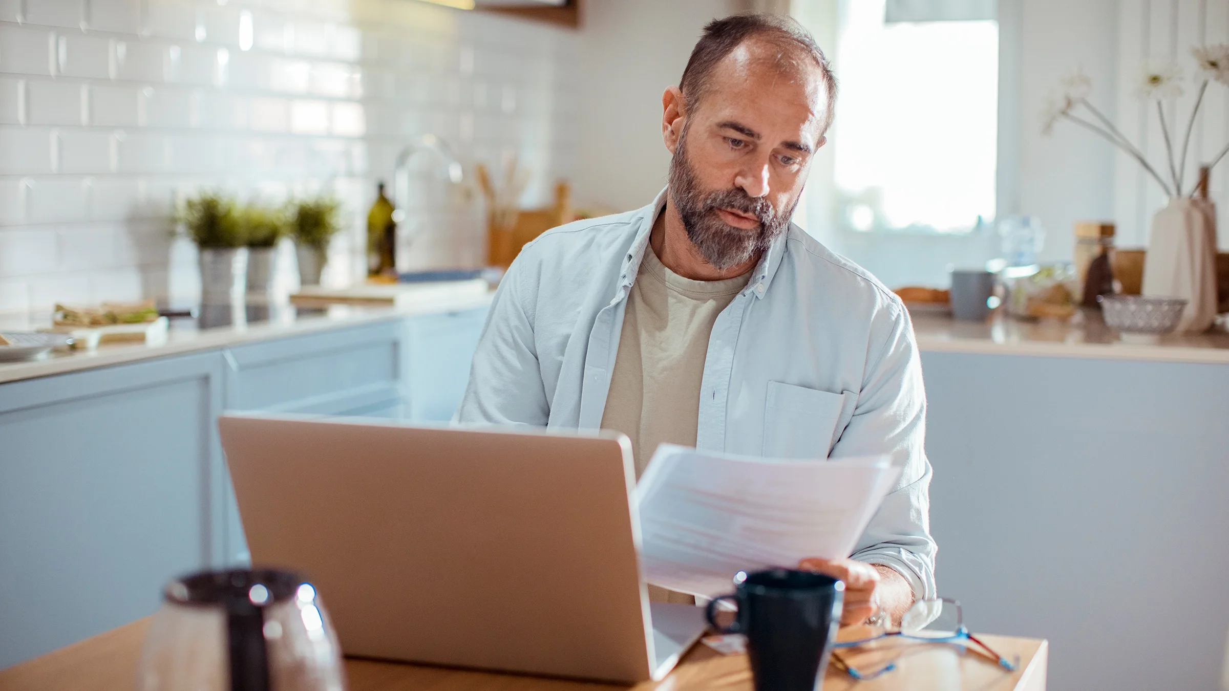 A man does paperwork at home.