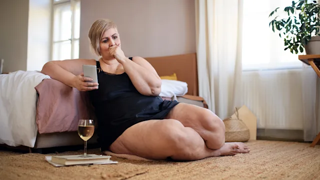 Alcohol: woman drinking wine at home 1406550841
