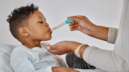 Young little boy taking medicine from dropper.
PeopleImages/iStock via Getty Images