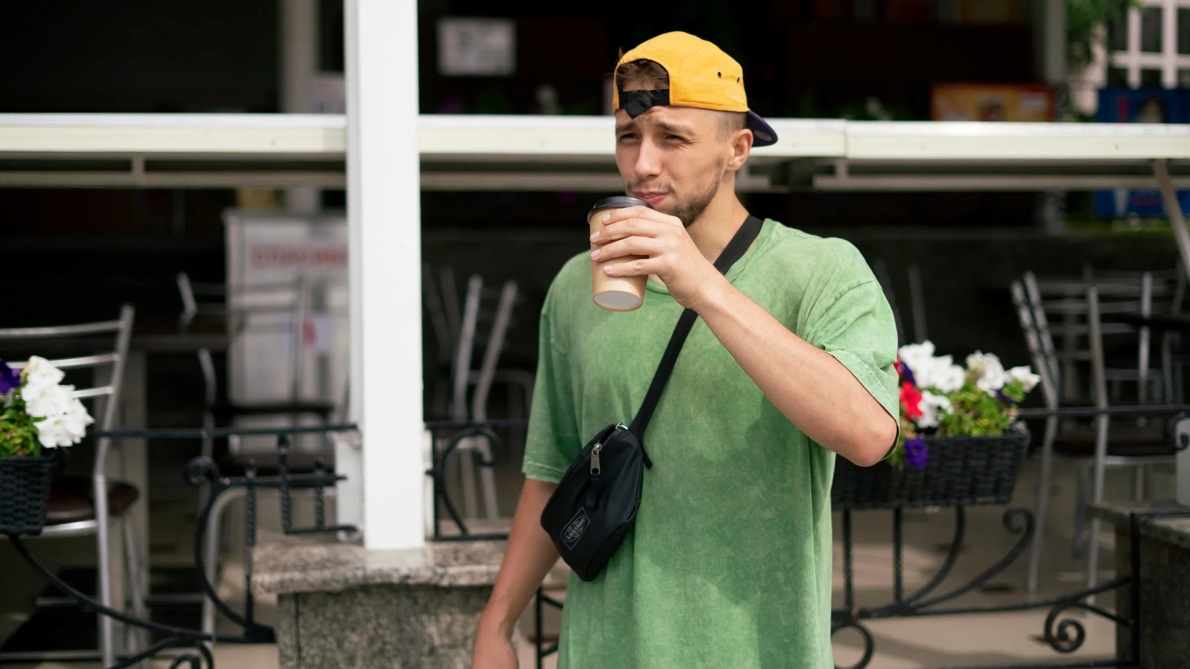 A person drinking coffee outside.
