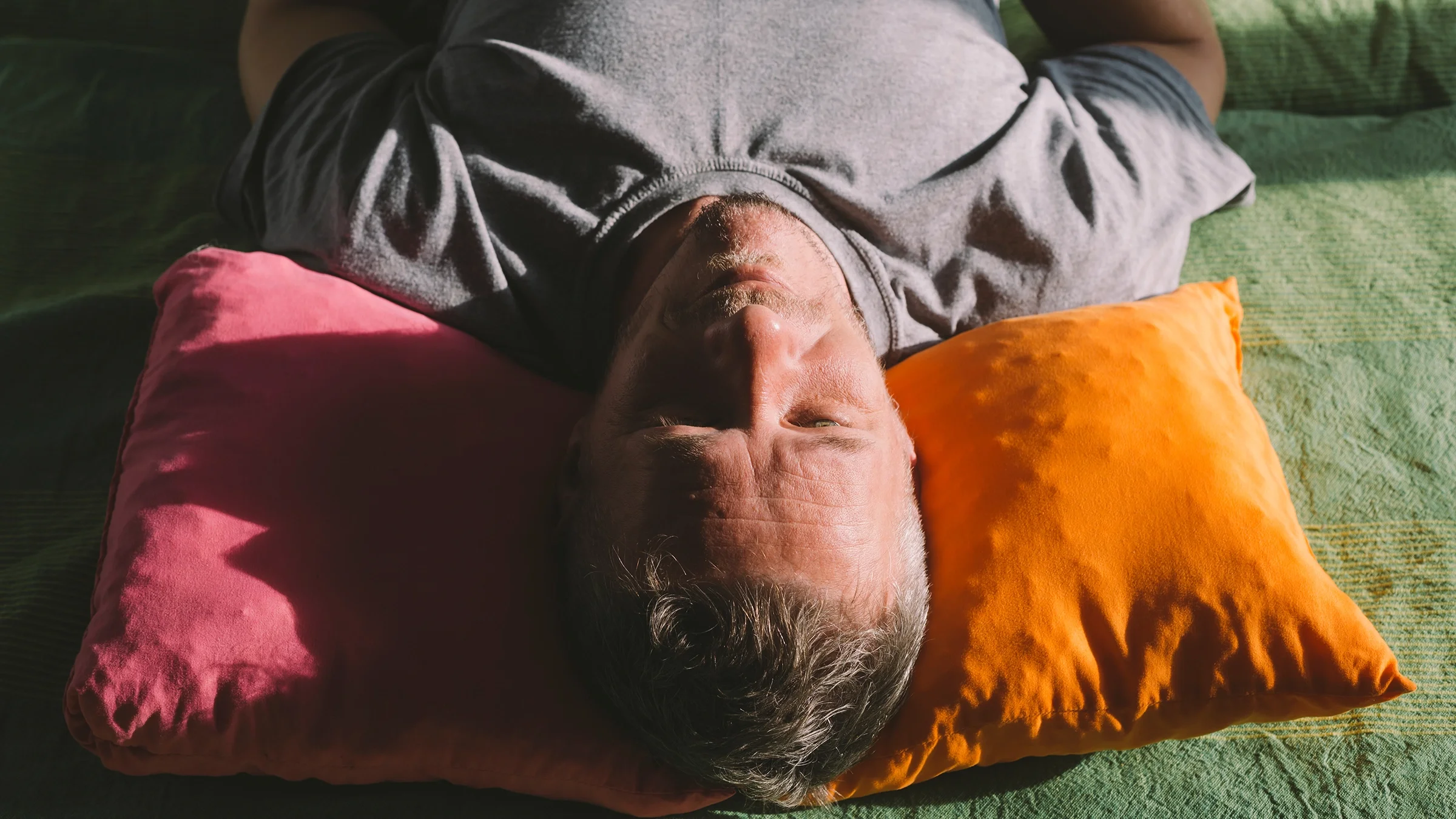 A man sleeps on his back. 