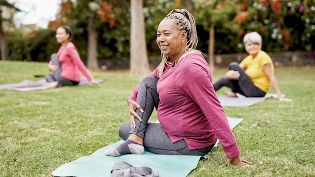 Health: Addiction: senior women yoga in the park 1308292203