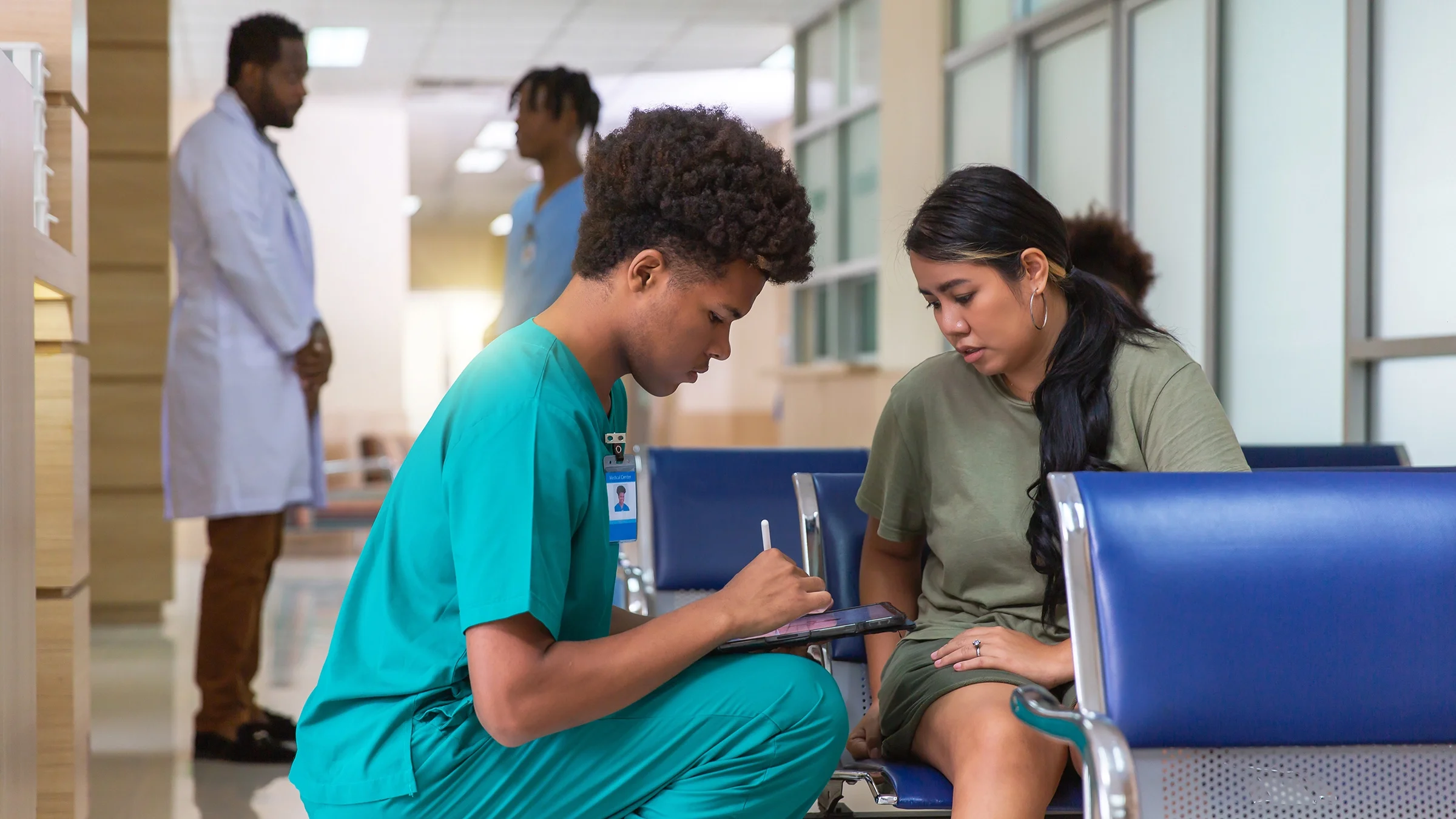 A woman checks in at a healthcare facility.