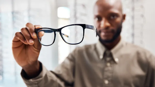 Eye: closeup man holding glasses 1305313819