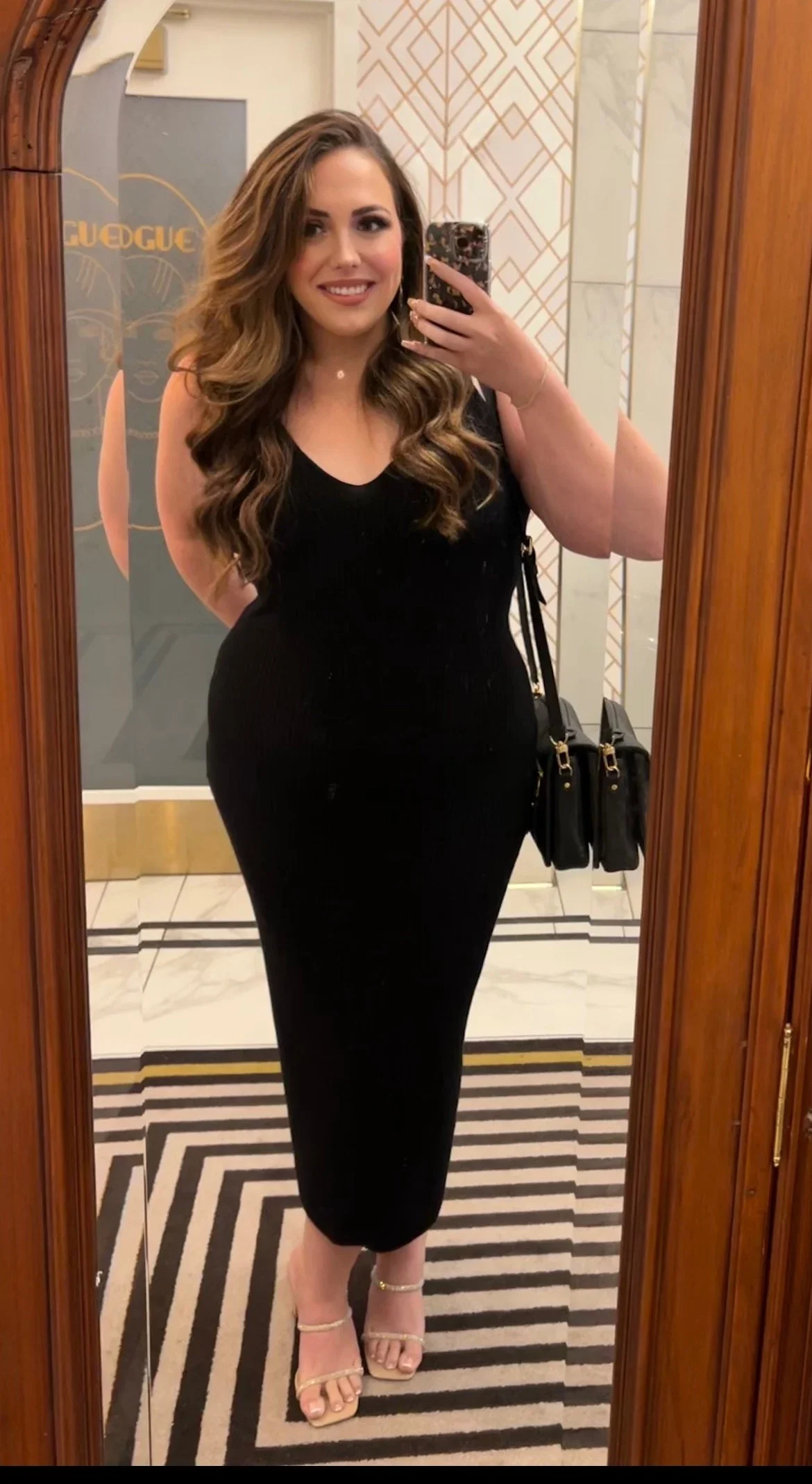 Michaela Pearson is pictured in a mirror selfie, dressed in a long, black gown after losing 115 lbs.