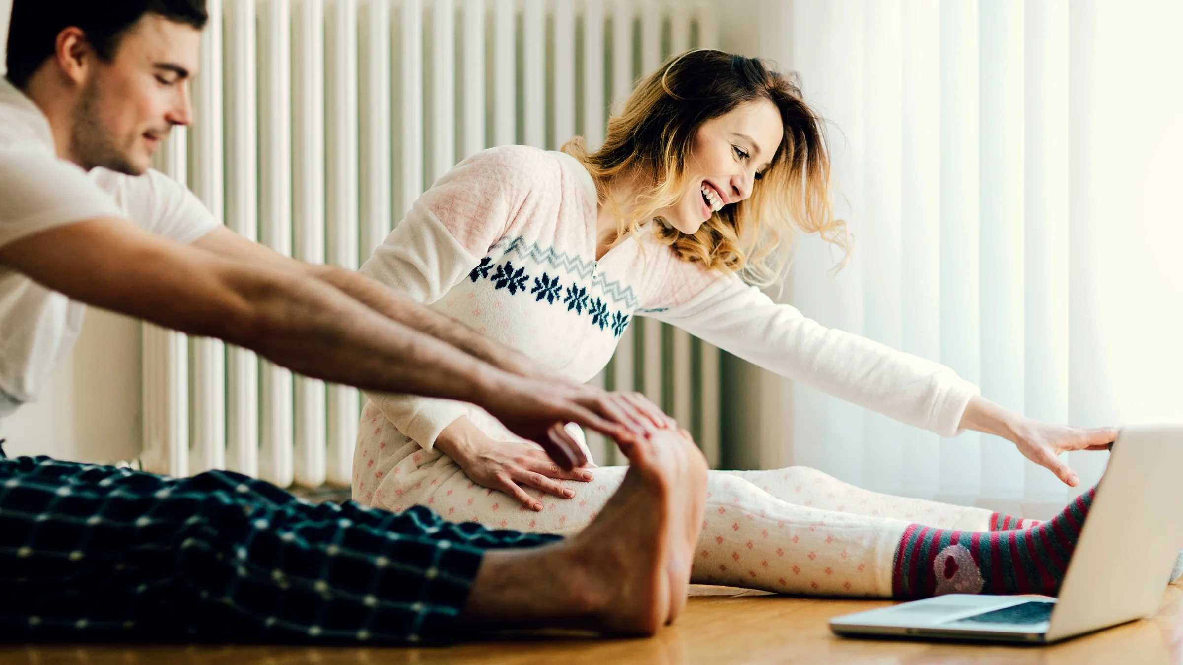 A couple exercising while wearing pajamas.