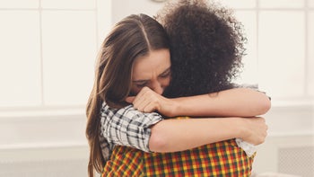 Mental health: comforting friend with hug 909514834.jpg