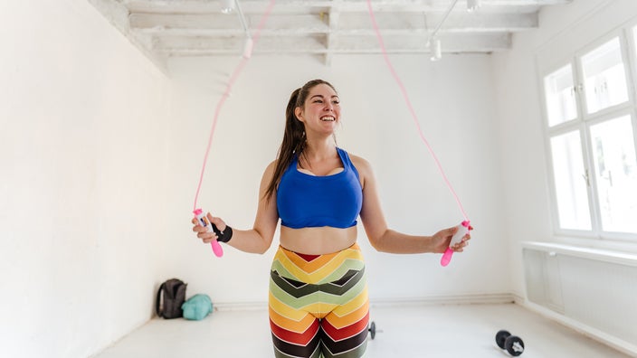 A woman is doing jump rope exercises.