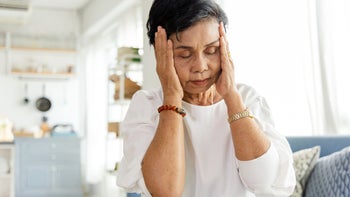 Migraine: senior woman with migraine 1323957179