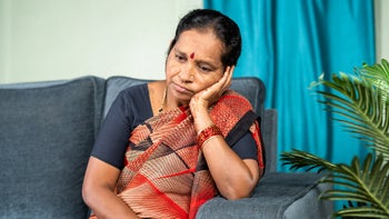 UTI: Confusion: older woman thinking on couch-1403272832