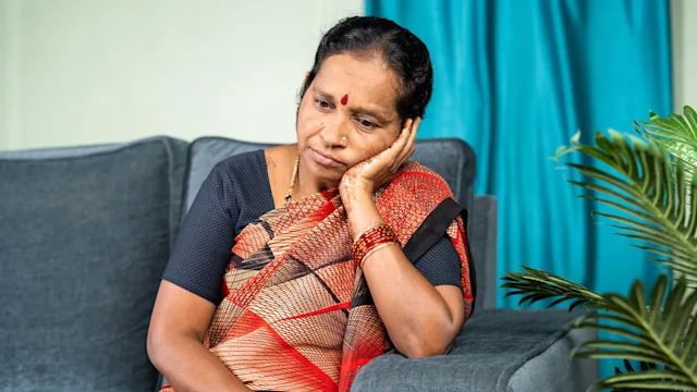 UTI: Confusion: older woman thinking on couch-1403272832