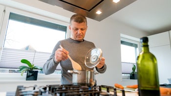 Diet and nutrition: man cooking with olive oil 643421254