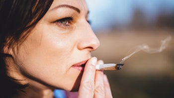 Smoking cessation: portrait of woman smoking cigarettes 926192794