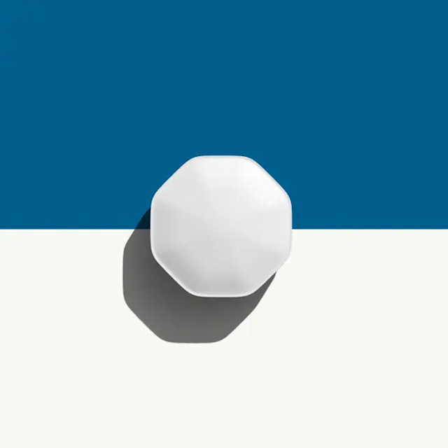 Finasteride prescription online. Beige, oval-shaped pill on a yellow and white background.