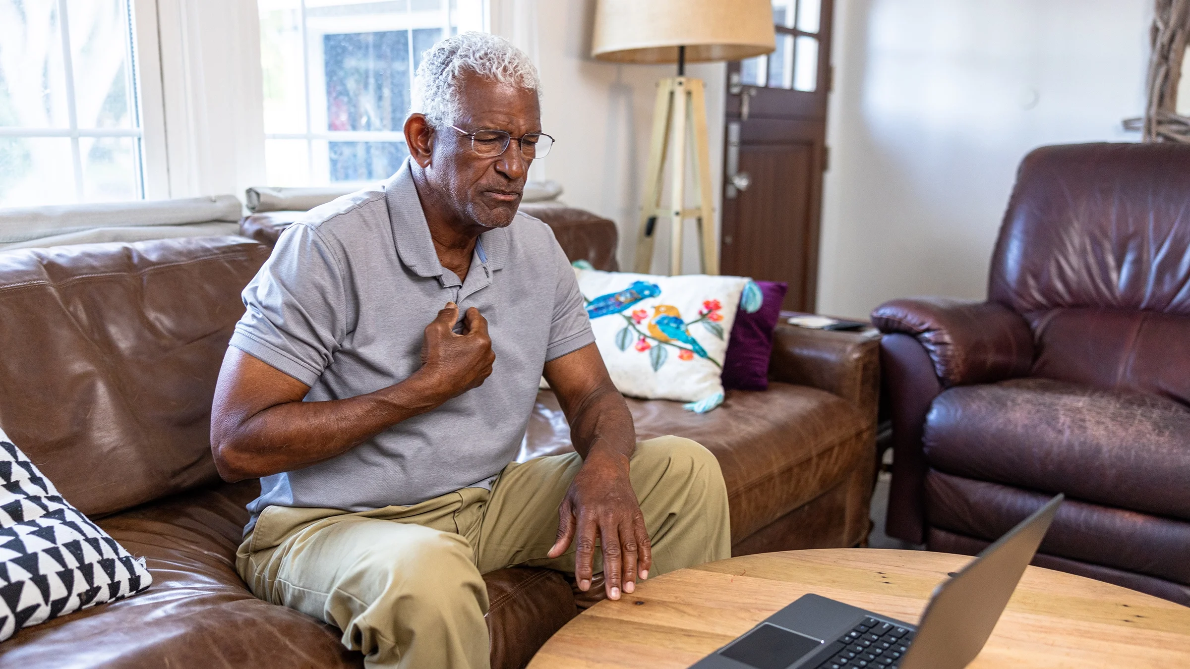 An older man is on a telemedicine call with a healthcare professional.