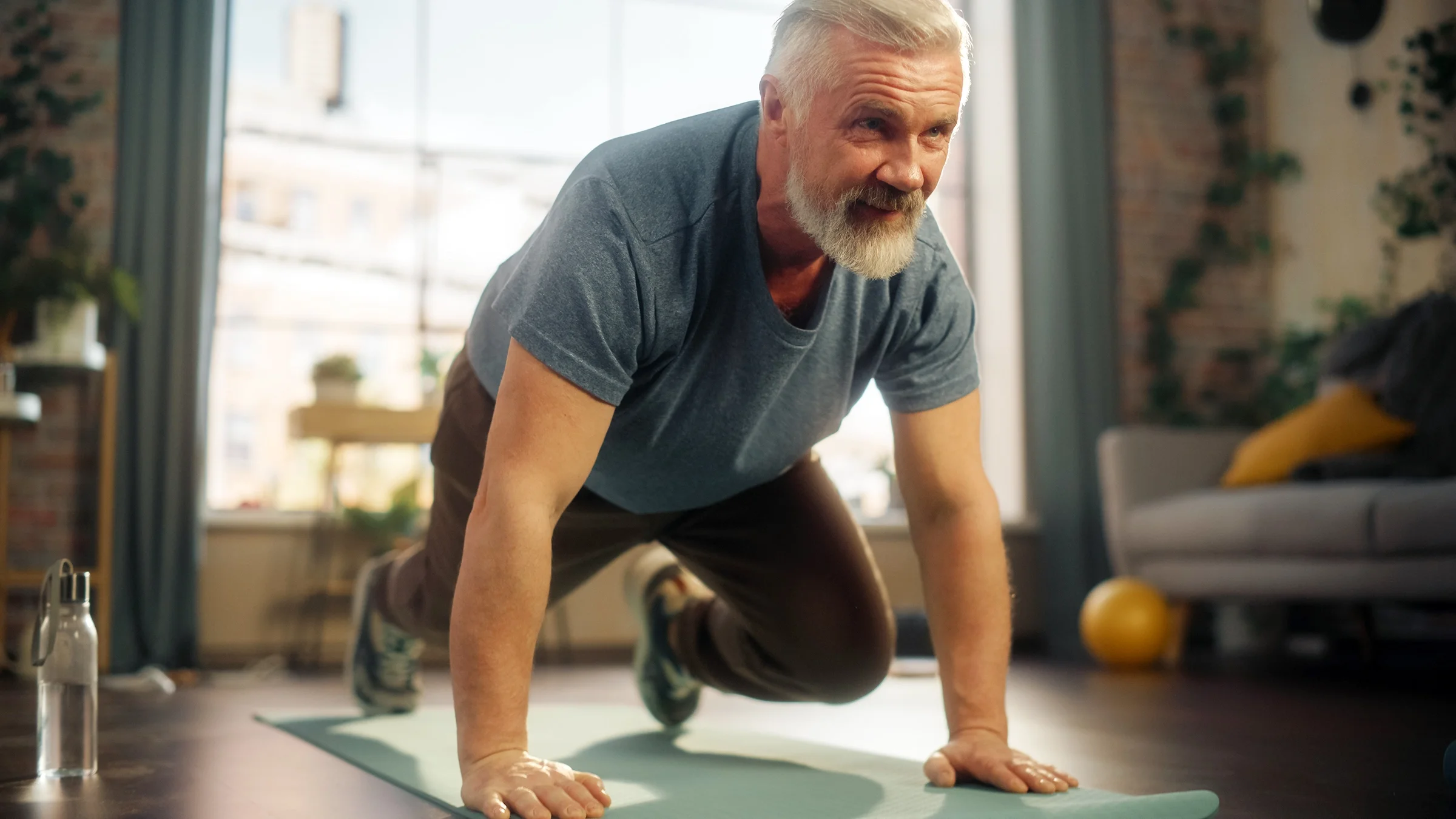 Man doing mountain climber exercise on a yoga mat at home