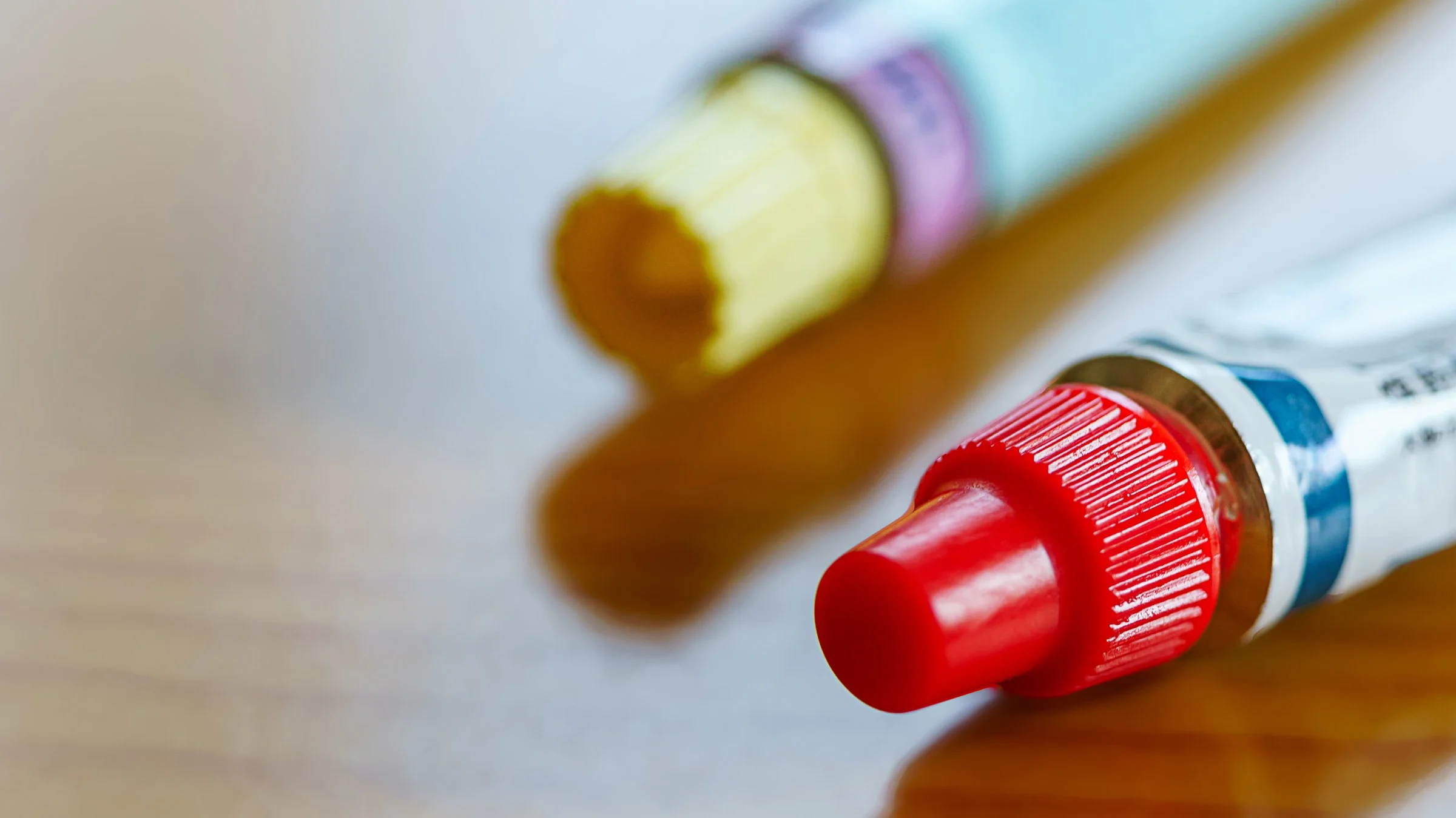 Two ointments tubes next to each other. 