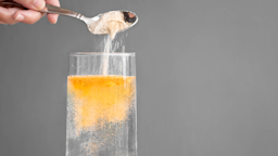 Close-up shows powder supplement being poured into a glass of water.
globalmoments/iStock via Getty Images Plus
