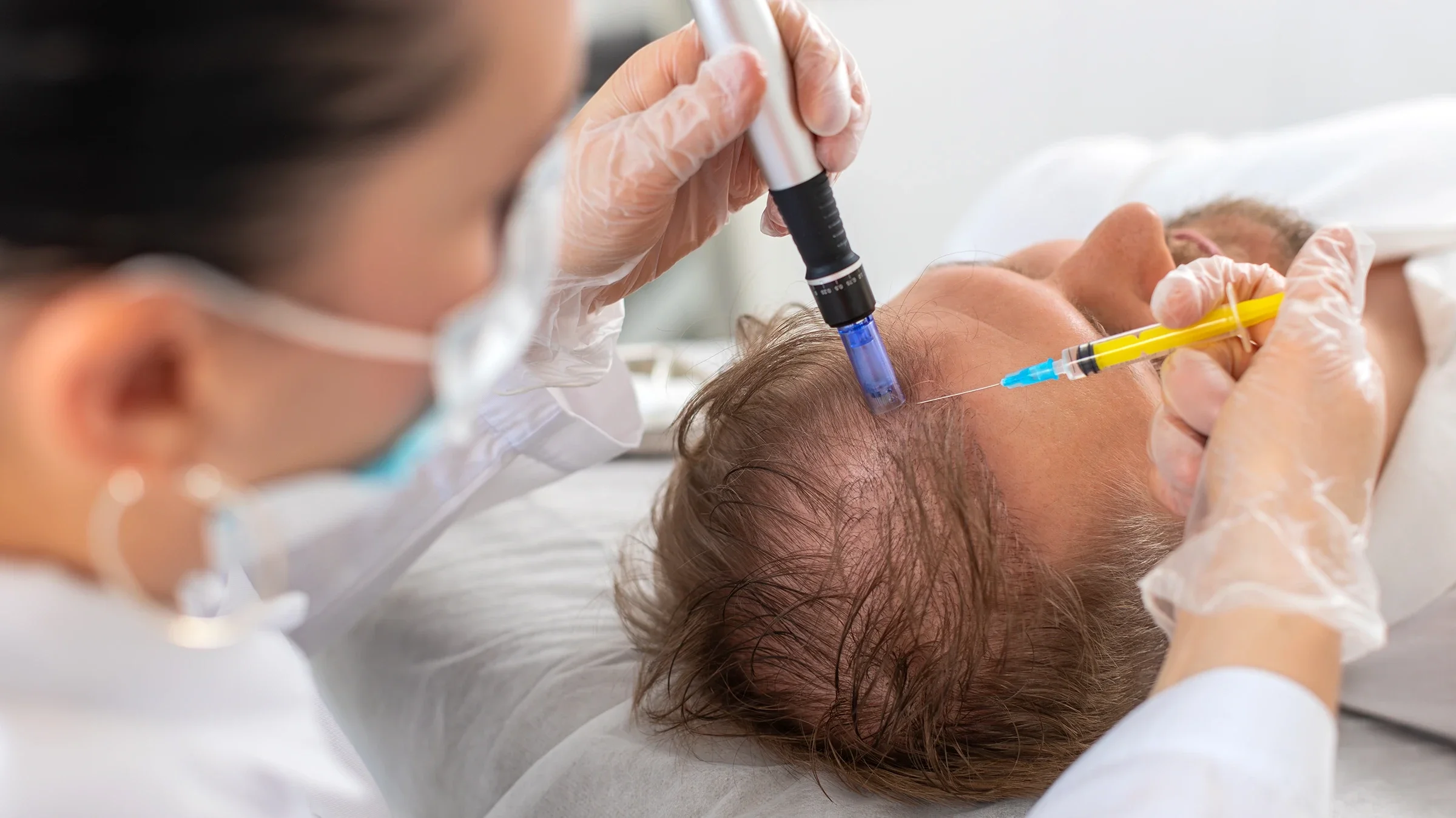 A patient receives a hair growth treatment.