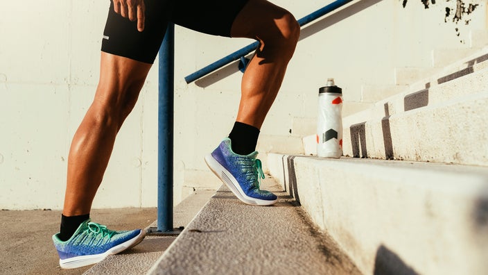 Close-up of man stretching his calves.