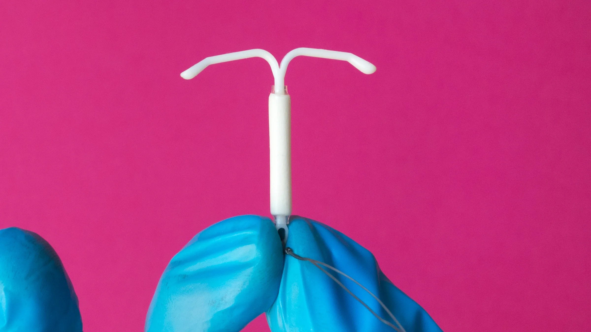 Close-up hand holding an IUD