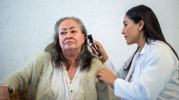 Ear: doctor examining older adults ear 1311708842