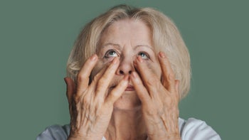 dermatology: senior woman applying eye cream 1470101684