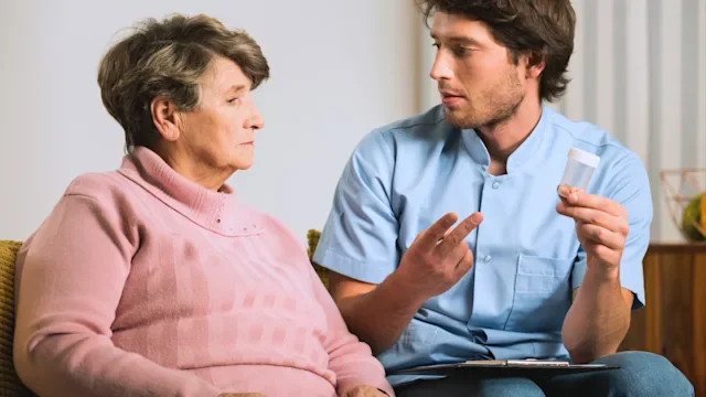 Weight loss: Metformin: hcp explaining pill to senior woman 513390284