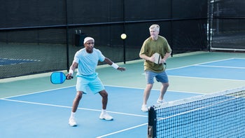 Health: movement-exercise: older men playing pickleball-1298023430