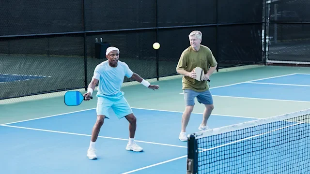 Health: movement-exercise: older men playing pickleball-1298023430