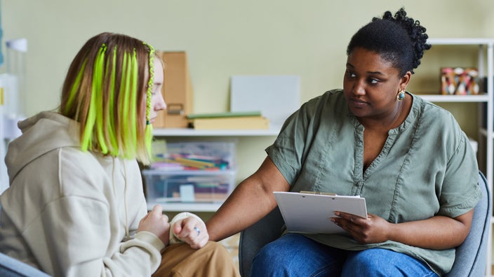 A counselor comforting a depressed teen.