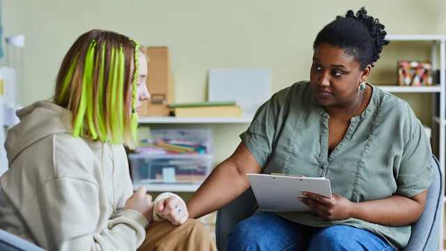 Substance use: counselor comforting depressed teen 1405778996