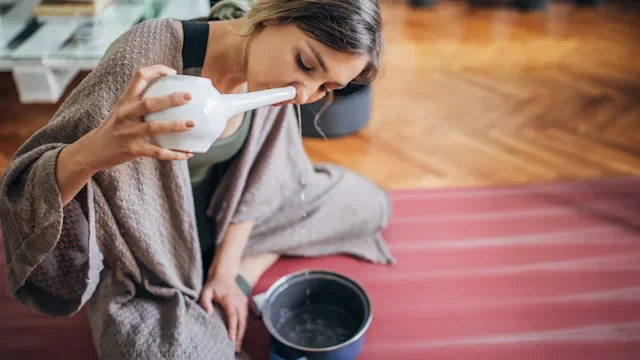 Health: Sinus Infection: woman using net pot at home 1243166474