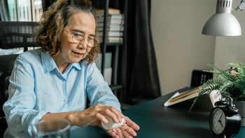 Kidney disease: senior woman taking medication 1284715278