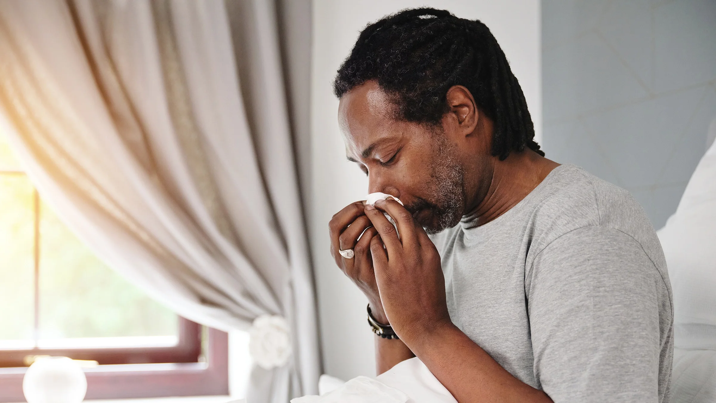 Man blowing his nose
