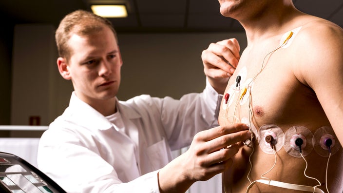 A doctor conducting an ECG test on a patient.