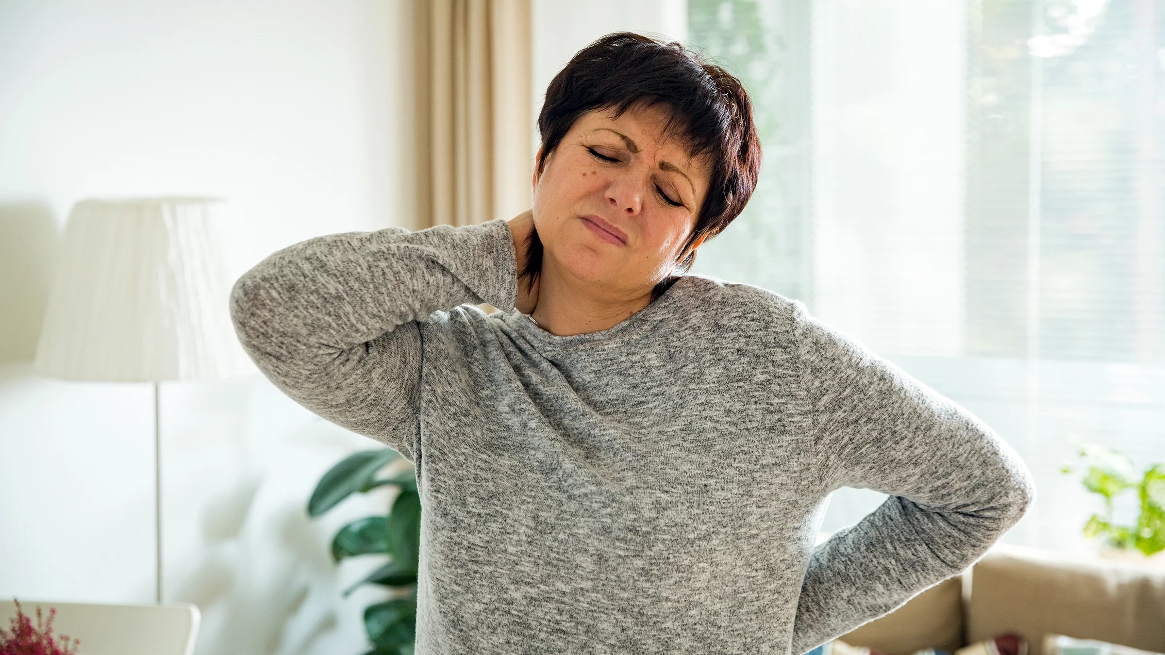 Woman with body aches at home.
