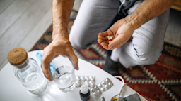 Senior man at home taking medications from a daily pill organizer box.
hobo_018/E+ via Getty Images
