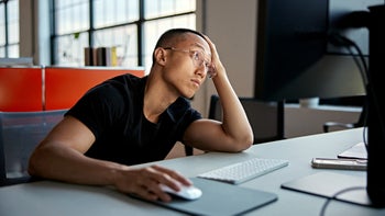 Behavioral addiction: man bored on desktop computer 1718111873