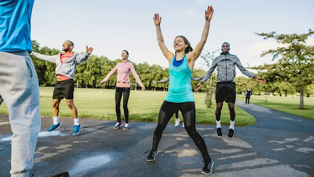 Movement exercise: group doing jumping jacks 959161726