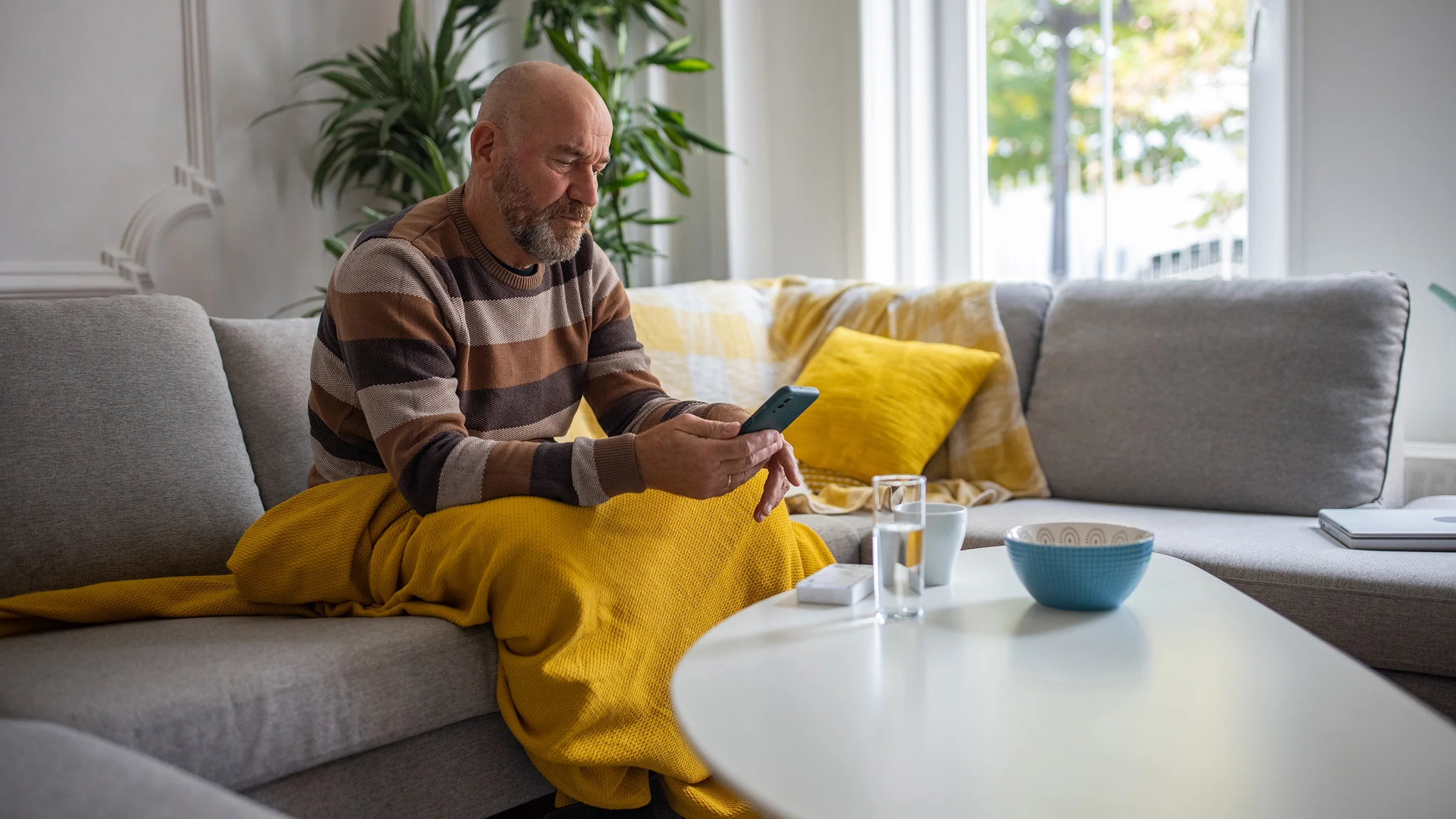 A man uses his phone at home.