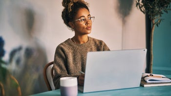 Health: Neurological: young woman working on laptop at coffee shop 1283960827