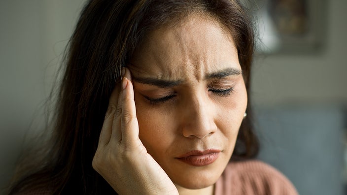 Close-up of a person experiencing a headache.