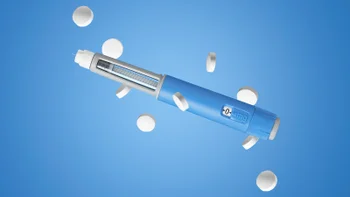 GLP-1: weightloss pen and pills on blue background 2265989306