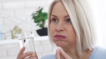 Medication Education: woman taking pill 1141424751